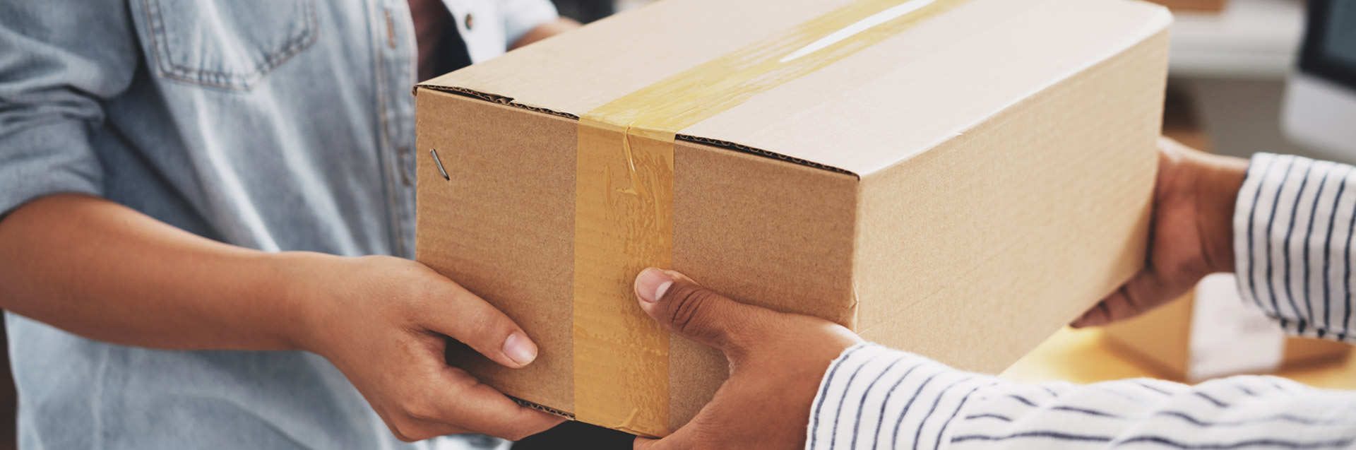 Two people handling a box