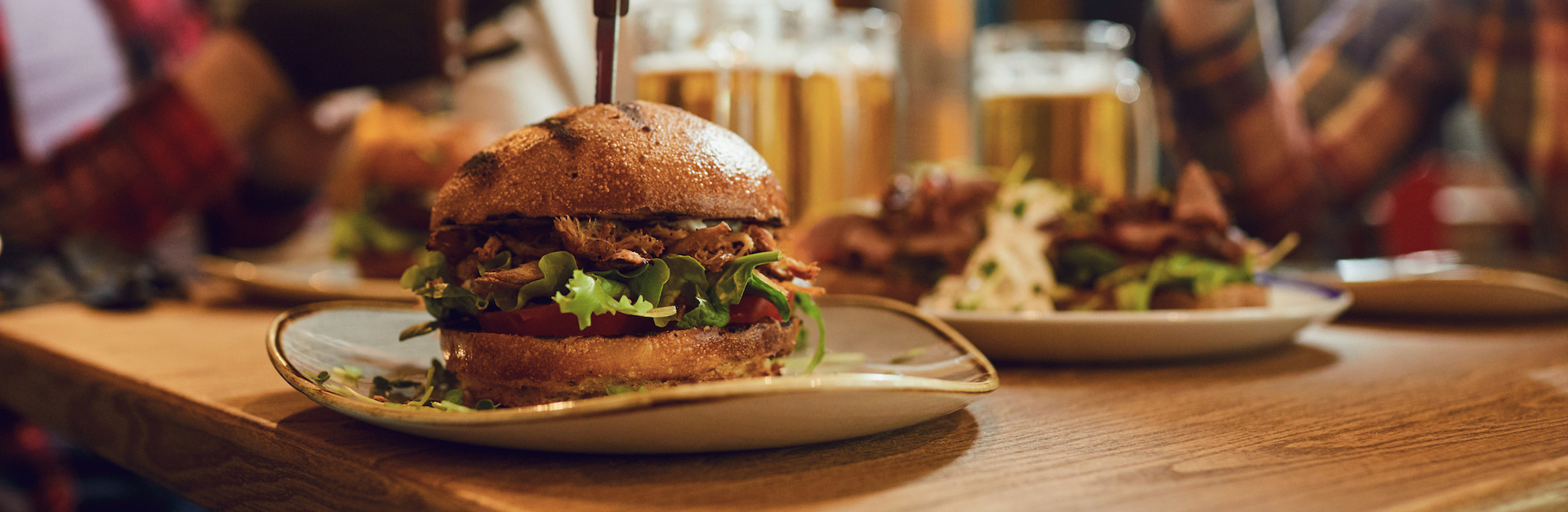 Burger With Beer On The Table In A Bar Pub.