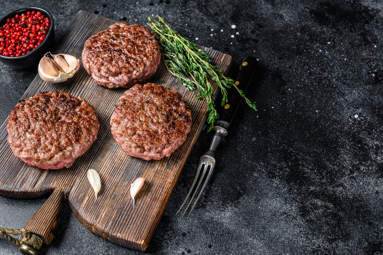 Bbq Grilled Beef Meat Patties For Burger From Mince Meat And Herbs On A Wooden Board. Black Background. Top View. Copy Space